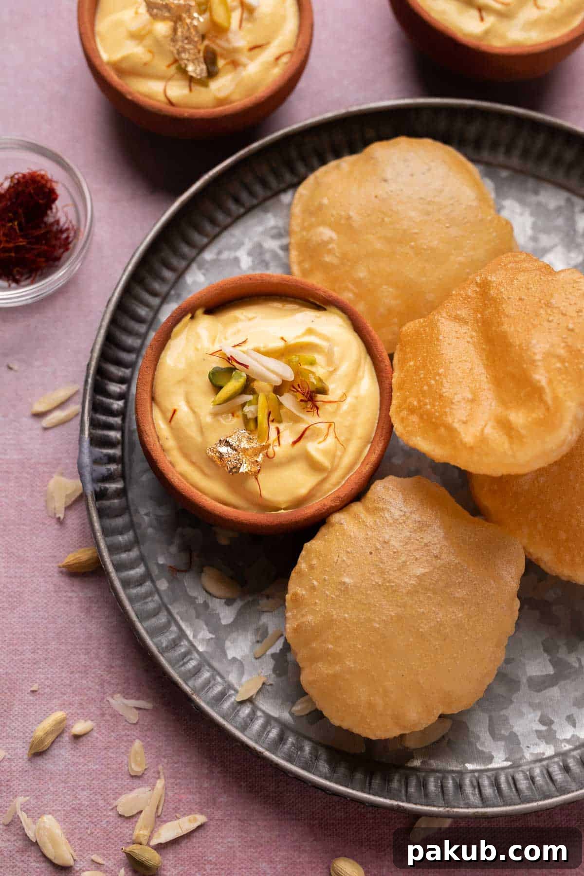 Creamy Mango Shrikhand Delight 2 Mango Shrikhand served on a plate with pooris