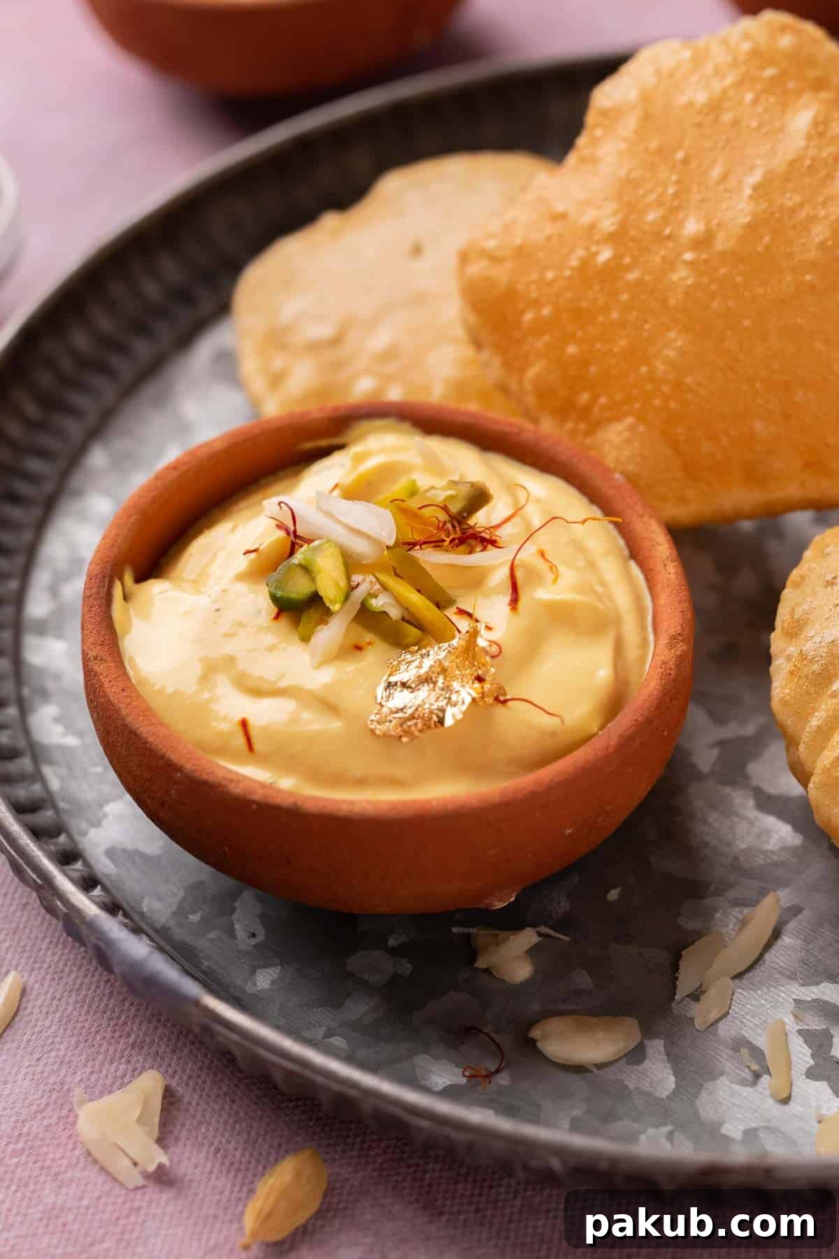 Creamy Mango Shrikhand Delight 4 Mango Shrikhand served on a plate with pooris
