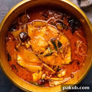 Raw Mango Fish Curry served in a brass pot that it was cooked in