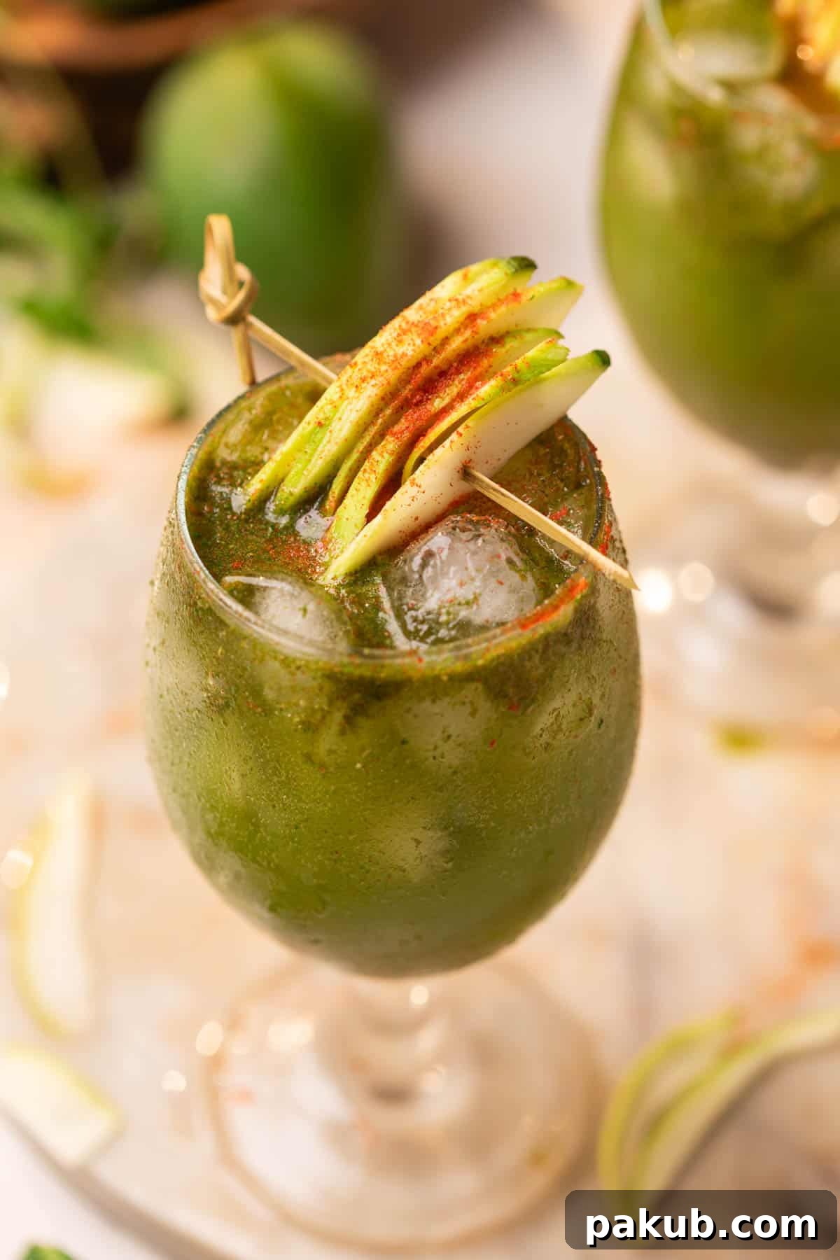 Aam Panna served in a glass and garnished with raw mango slices and chili powder, ready to refresh on a hot summer day.