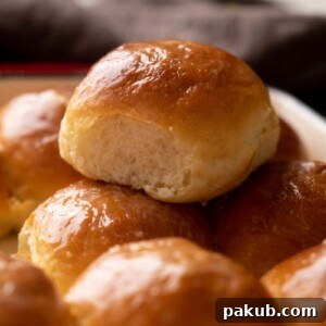 Single ladi pav stacked on top of other baked ladi pavs, showing their soft, fluffy texture