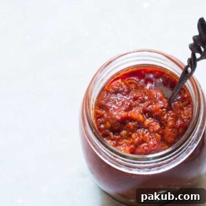 Fiery Schezwan Sauce stored in a glass jar, ready for use.