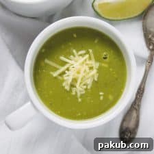 Pressure Cooker Zucchini Basil Soup served elegantly in white cups with a side of delicious bread.