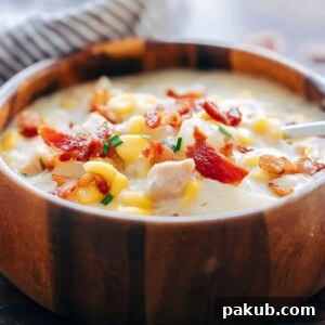 Instant Pot Chicken Potato Corn Chowder with Bacon, served in a rustic wooden bowl, offering ultimate comfort.