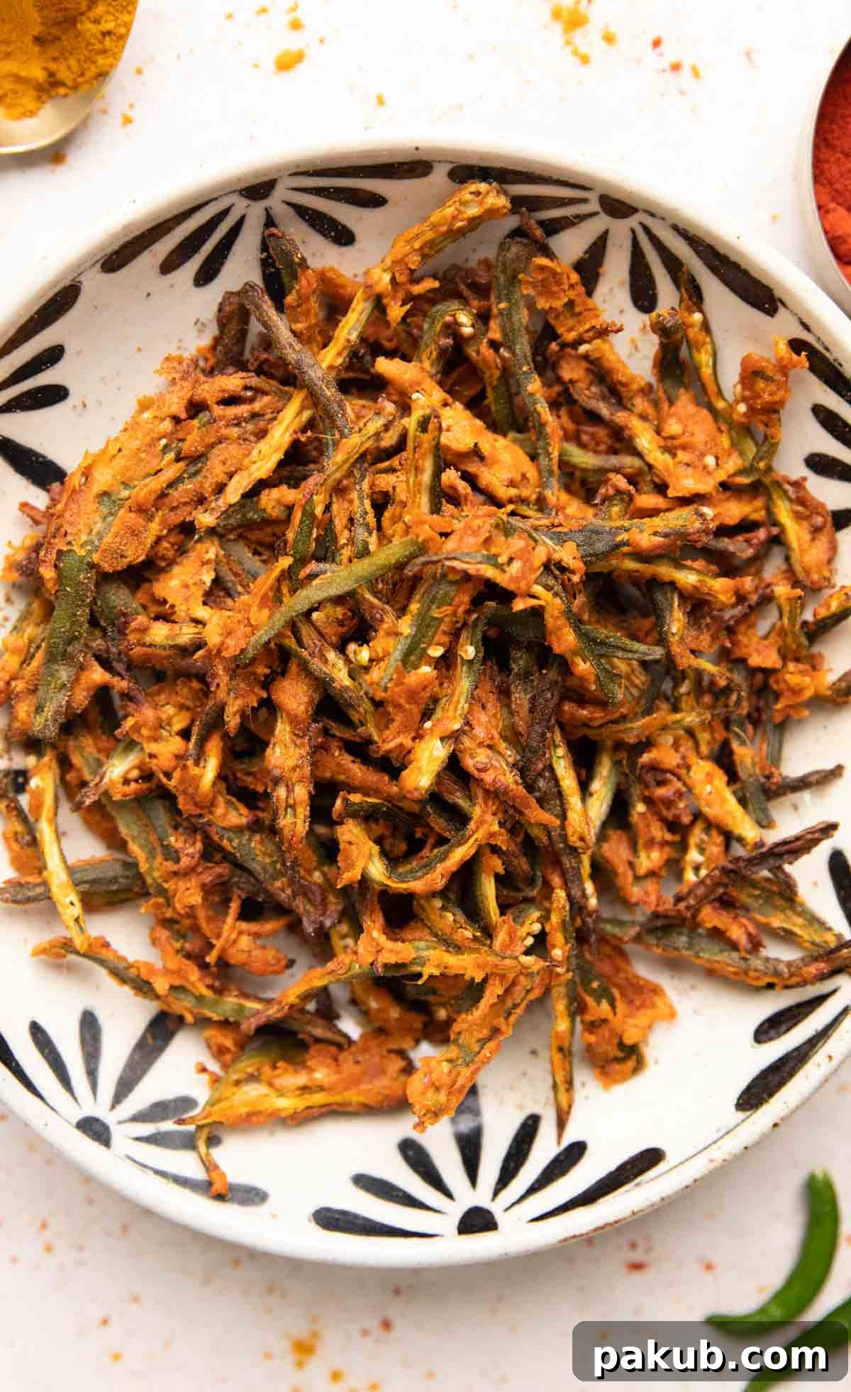 Crispy Air Fryer Okra 2 Crispy Air Fried Kurkuri Bhindi served in an elegant white bowl, garnished and ready to eat.