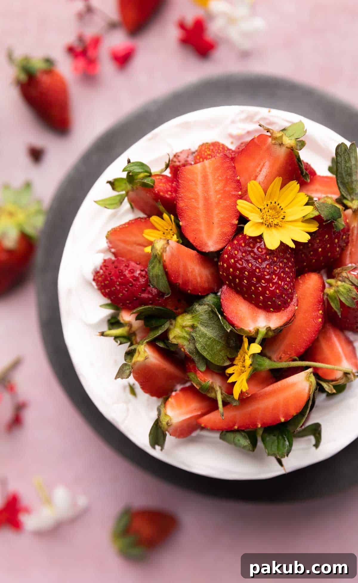 Effortless Air Fryer Vanilla Sponge Perfectly Egg-Free 7 A beautifully frosted vanilla air fryer cake topped with fresh strawberries, ready to be served, highlighting its delicious and inviting appearance.
