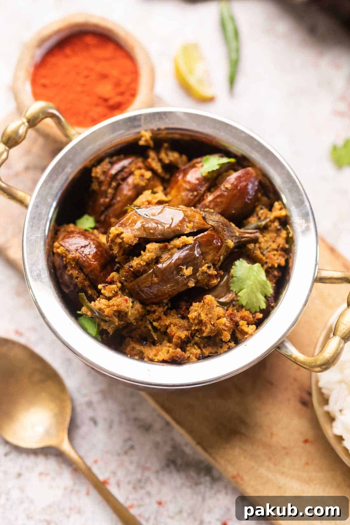 Flavorful Air Fryer Stuffed Eggplant 7 an image of air fryer stuffed brinjal garnished with coriander leaves and served in a handi