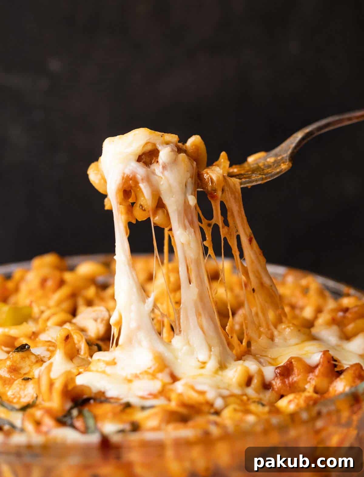 No-Boil Air Fryer Pasta Bake 2 Closeup of air fryer baked pasta in red sauce being eaten with a fork
