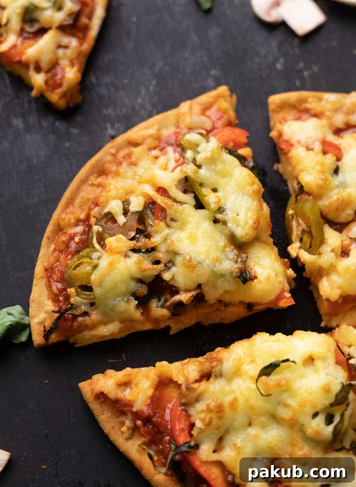 Quick Yeast-Free Air Fryer Pizza 6 A vibrant close-up of a perfectly baked air fried pizza with fresh basil leaves, showing a crispy crust and melted, golden cheese.