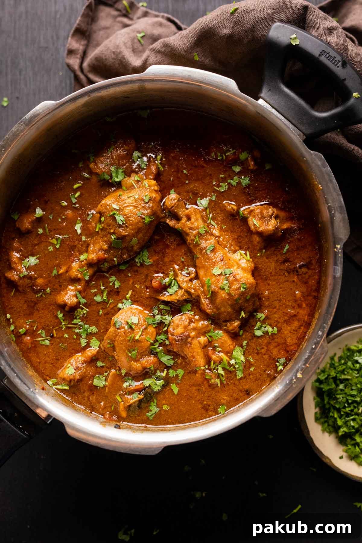 Dhaba style chicken curry served in the pressure cooker it was made in