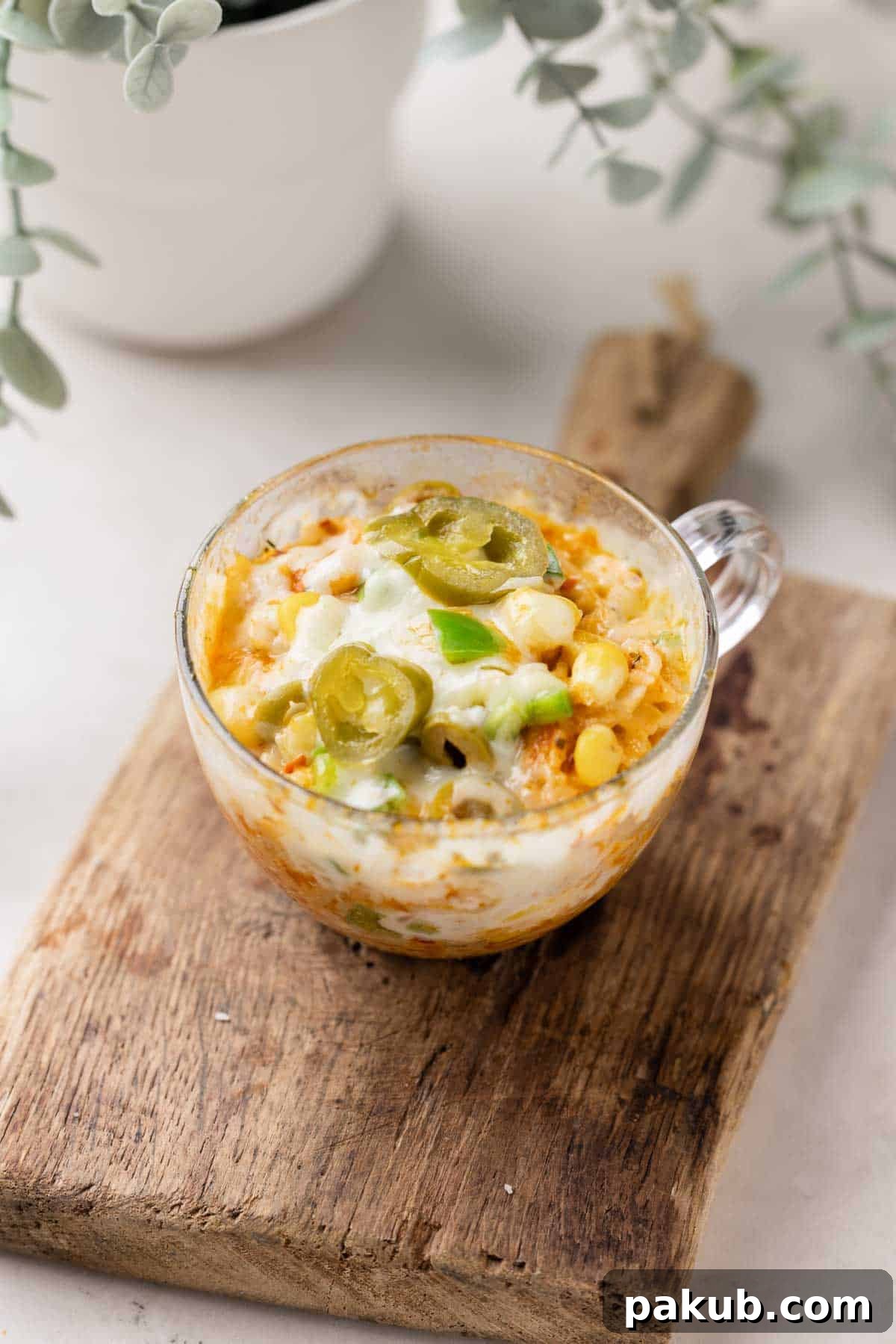 Savoury Mugs in Minutes 3 Close-up shot of microwave Mexican cheesy rice in a mug, topped with melted cheese and jalapeños