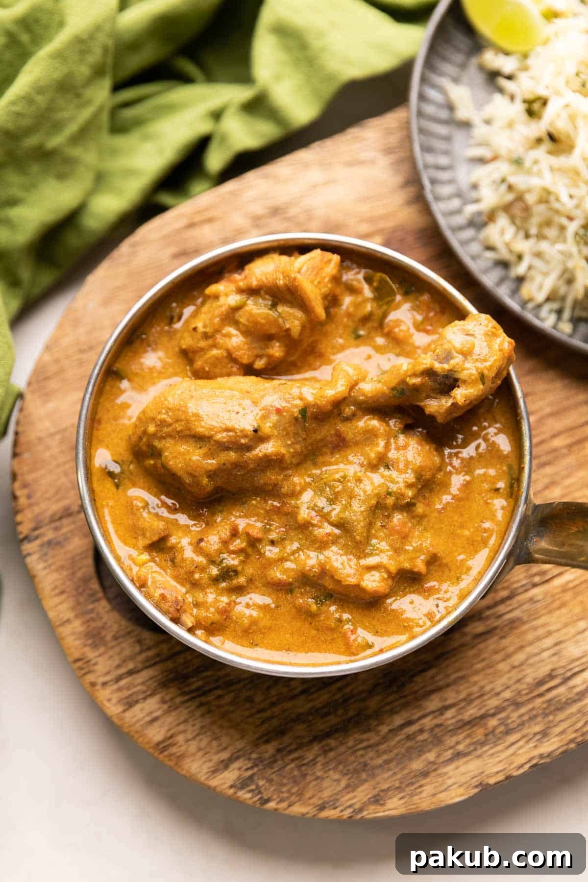 Creamy Instant Pot Coconut Chicken Curry 2 A beautifully presented bowl of creamy Instant Pot Coconut Chicken Curry, garnished with fresh herbs, alongside a portion of aromatic jeera rice.