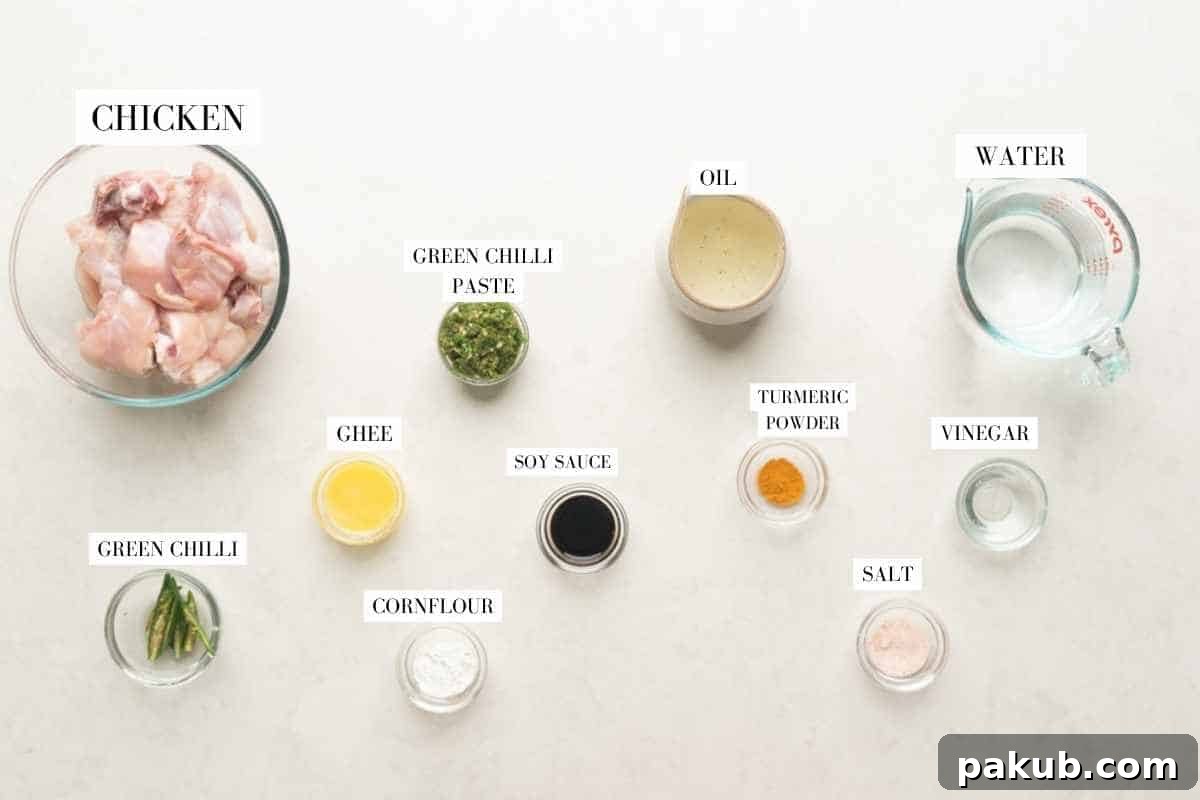A vibrant flat lay image showcasing all the fresh and whole ingredients needed to prepare Andhra Chilli Chicken, clearly labeled.