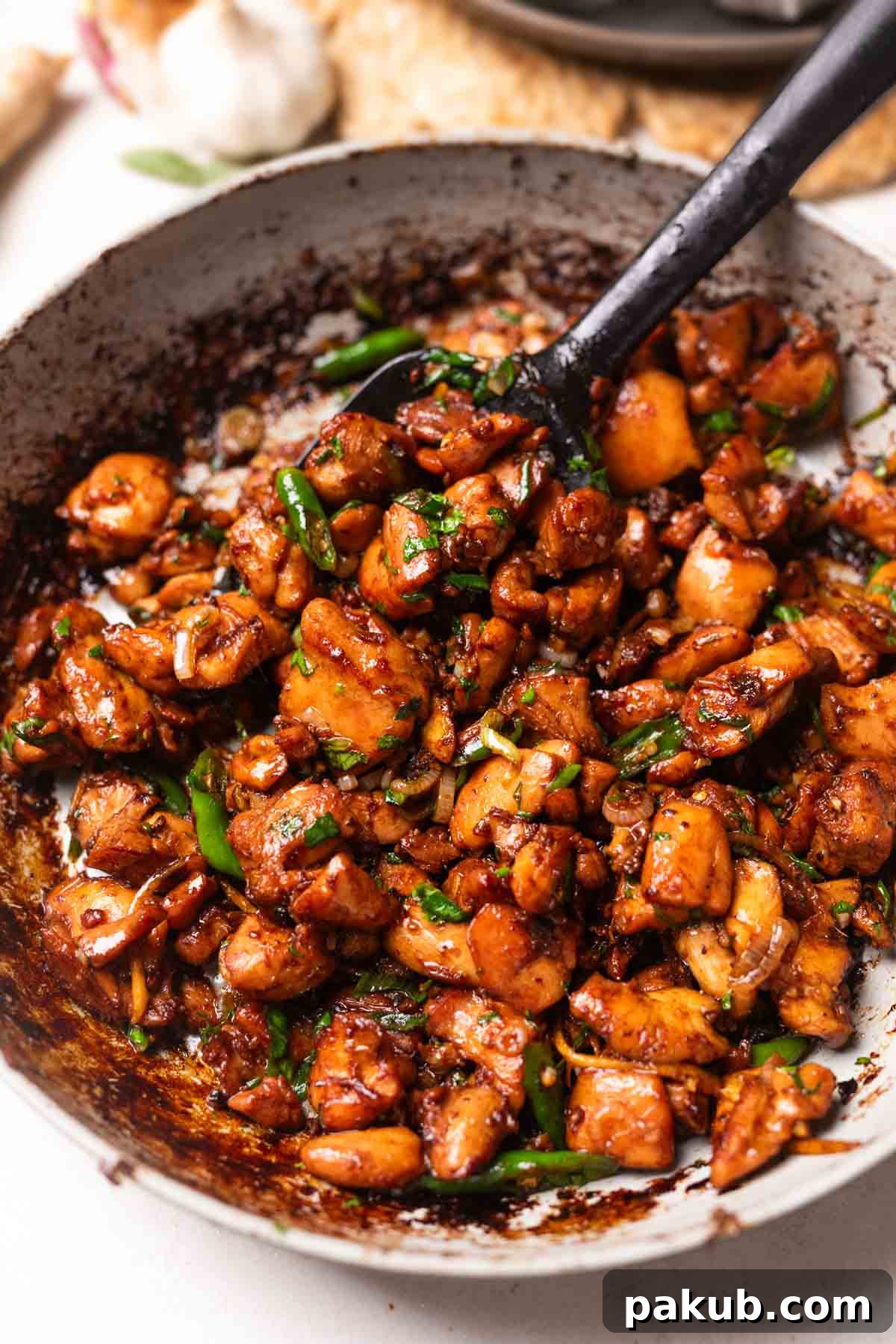 A vibrant ginger chicken stir fry served elegantly in a bowl, ready to be enjoyed with a spoon.
