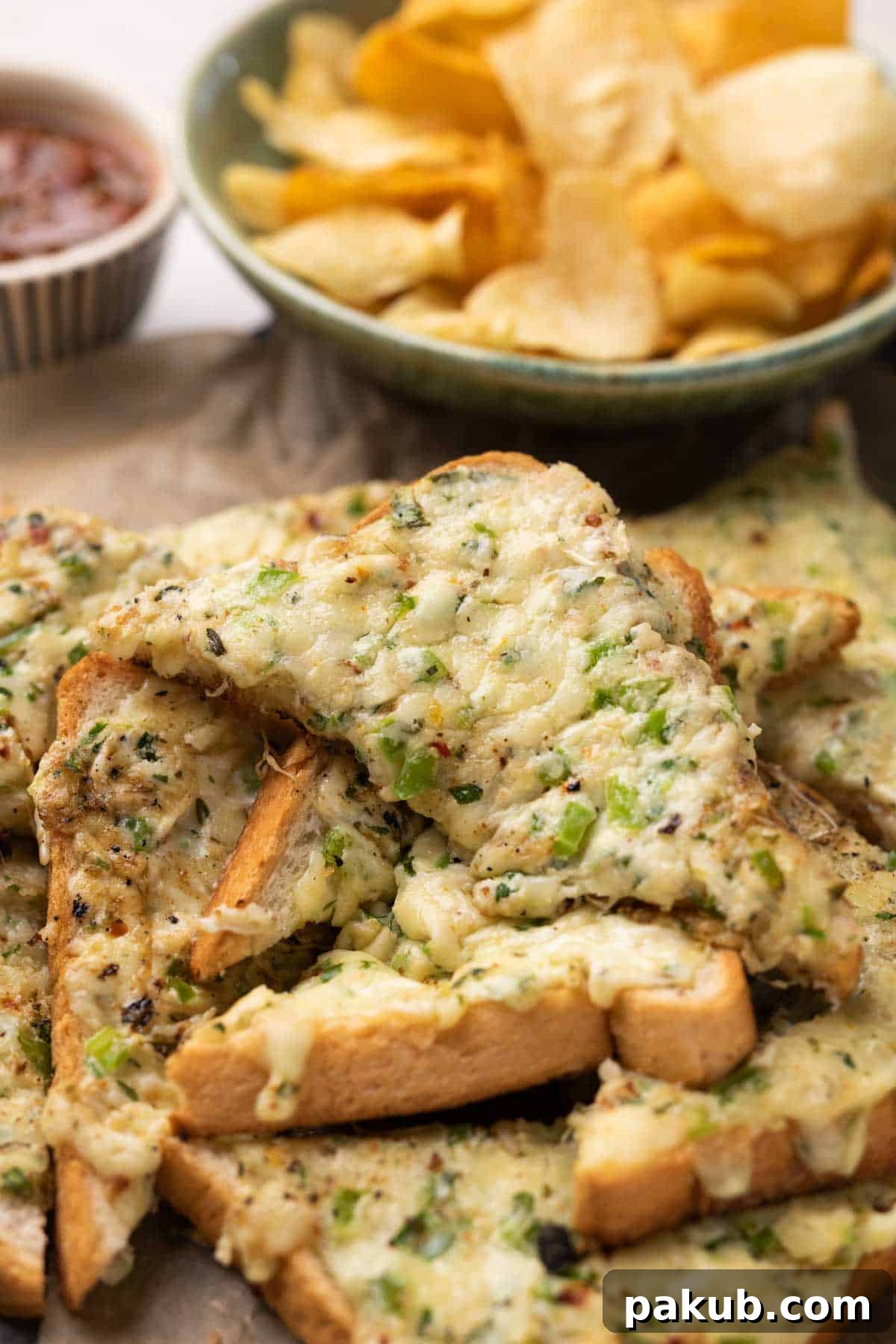 Fiery Cheese Garlic Bread 2 Golden brown chilli cheese garlic toasts generously topped with melted cheese, fresh green chilies, and herbs, arranged on a rustic platter.