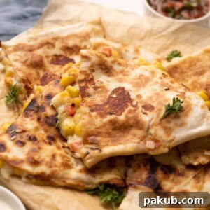 A perfectly cooked bell pepper, corn, and cheese quesadilla, golden brown and enticing, ready to be served.