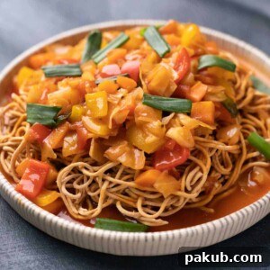 Crispy Noodle Nest with Tangy Sweet and Sour Vegetables 4 Sweet and Sour Vegetables served on crispy fried noodles in a white plate, garnished beautifully.
