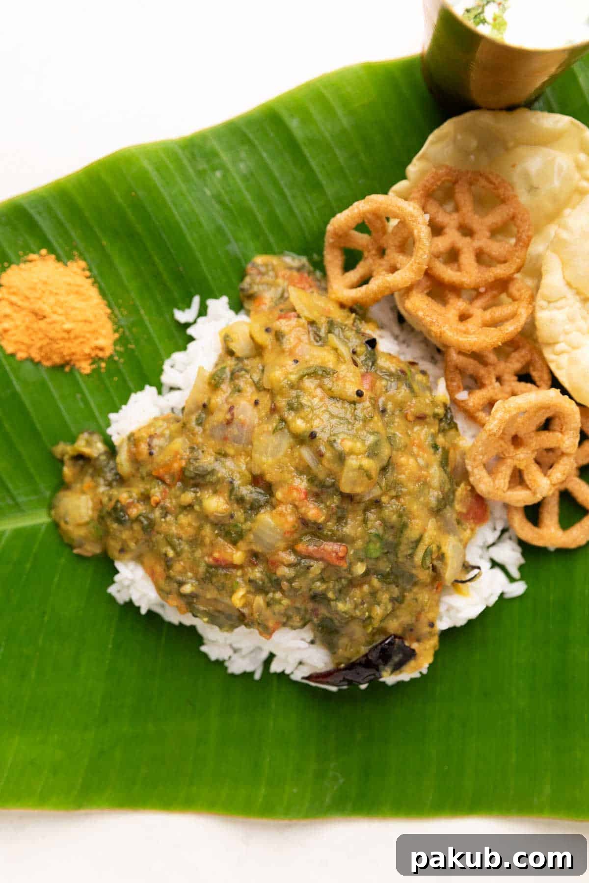Andhra Style Palak Pappu served in a bowl with steamed rice, a side of pickle, and papad, ready for a delicious meal