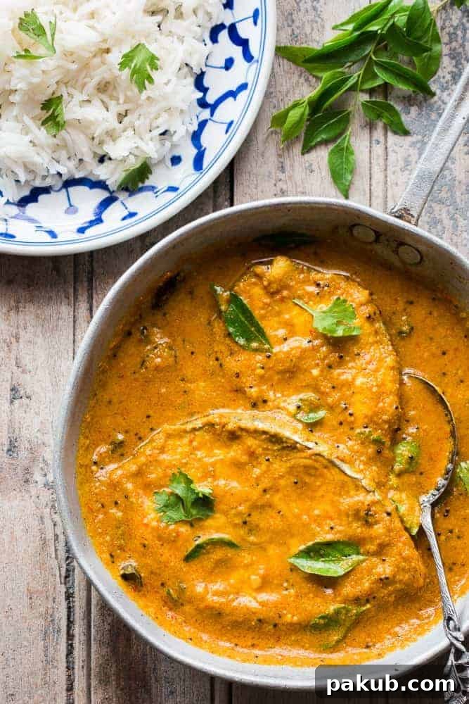 Safe Fish Thawing Methods 4 The kingfish curry garnished with curry leaves and served in a pan alongside rice.