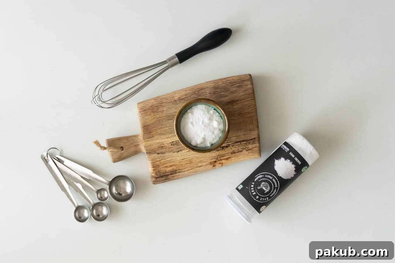 Another perspective of a cup of baking soda on a chopping board, with kitchen tools nearby, emphasizing its readiness for kitchen tasks.