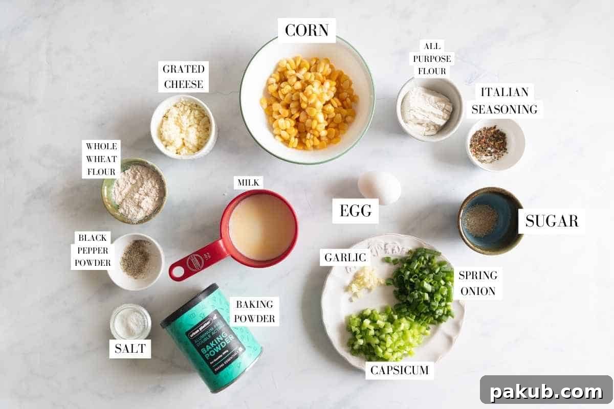 Golden Corn & Cheese Waffles 5 An organized flat lay of all fresh ingredients for savoury corn cheese waffles: corn, cheese, spring onions, capsicum, flours, egg, milk, and spices.