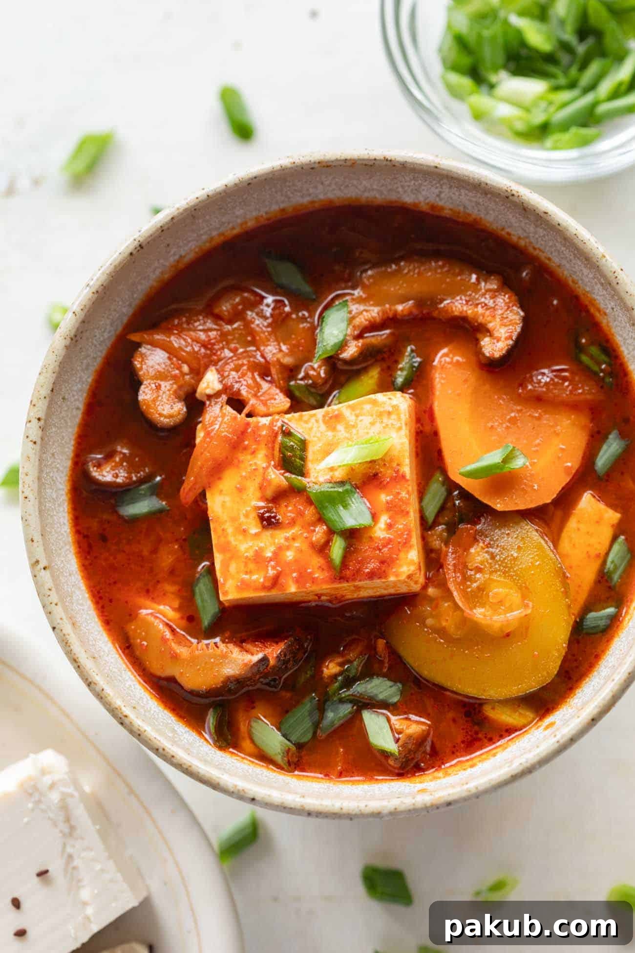 Fiery Silken Tofu Comfort 2 A vibrant bowl of Korean soft tofu stew, garnished and ready to serve