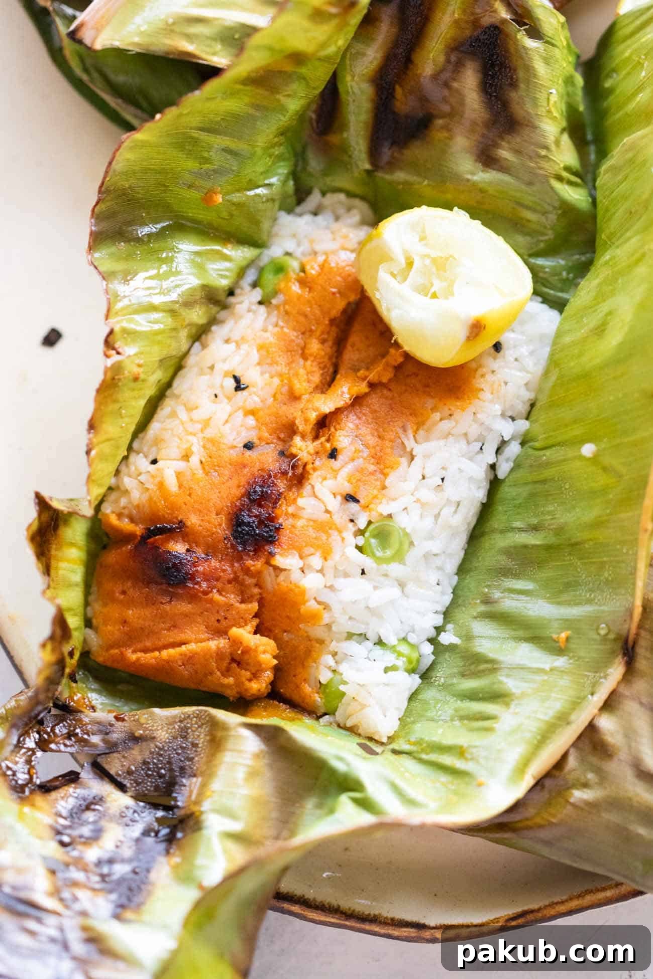 Aromatic Leaf-Wrapped Rice Parcels 8 A freshly opened Patra Rice parcel revealing the fragrant spiced rice and curry mixture inside.
