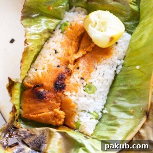 A beautiful close-up of a Patra Rice parcel on a banana leaf.