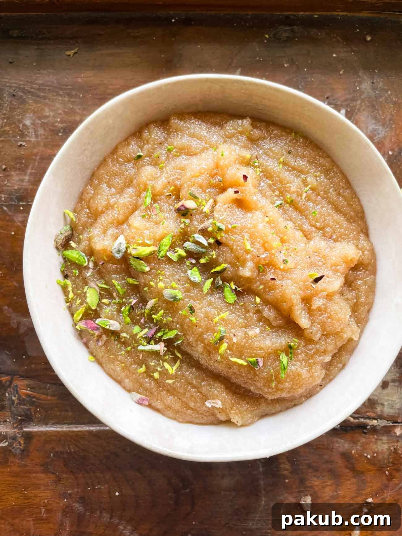 Irresistible Sooji Halwa 2 Delicious Sooji Halwa topped with sliced pistachios and served in a decorative bowl, ready to be enjoyed.