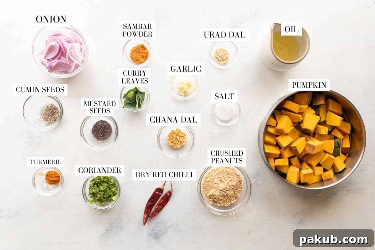 A vibrant assortment of ingredients laid out, including diced pumpkin, sliced onion, garlic, curry leaves, red chilies, lentils, peanuts, and spices.