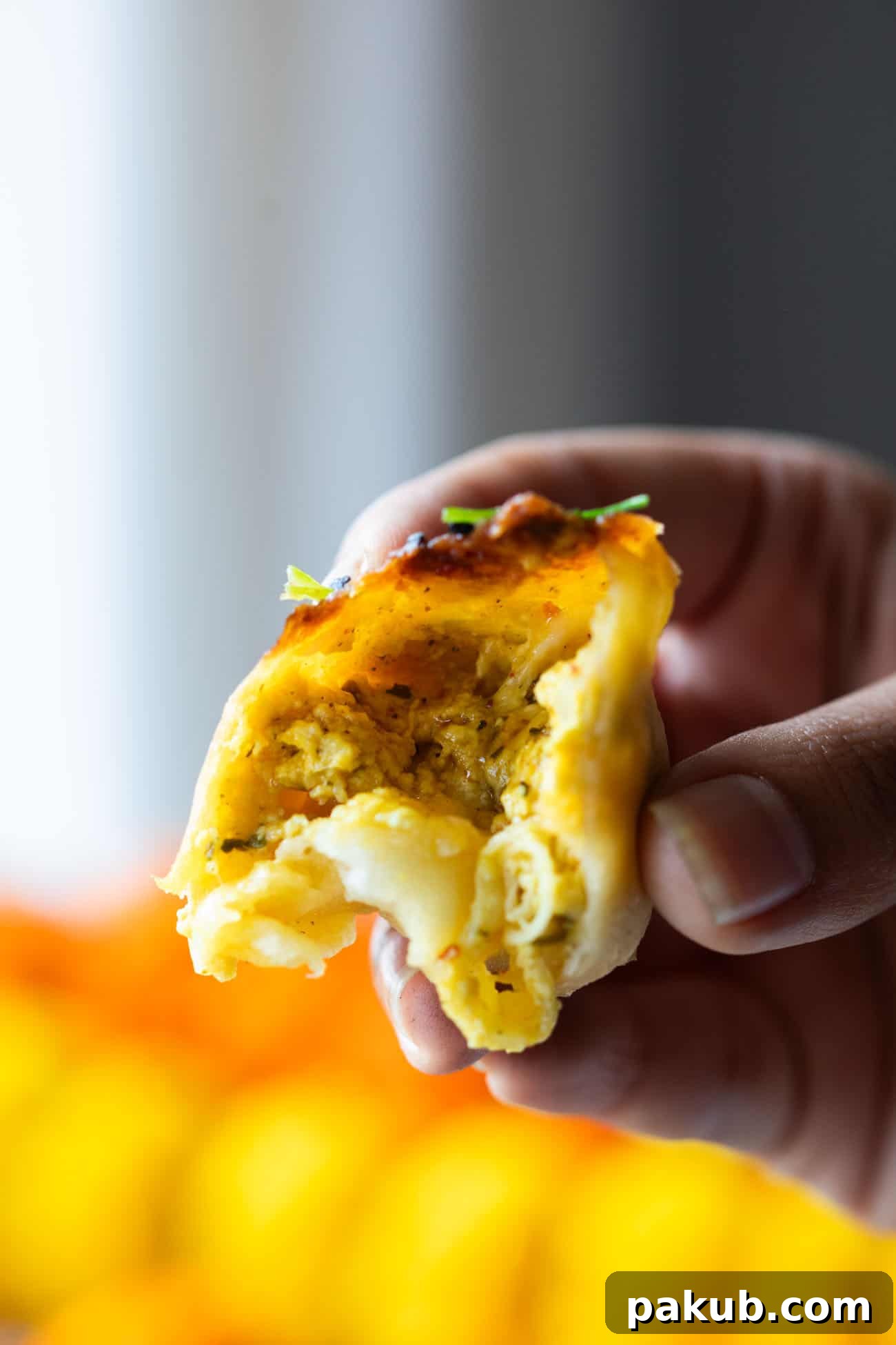 Tangy Achari Paneer Naan Poppers 5 A close-up view of the inside of an Achari Paneer Naan Bomb, showing the melted cheese and flavorful paneer filling.