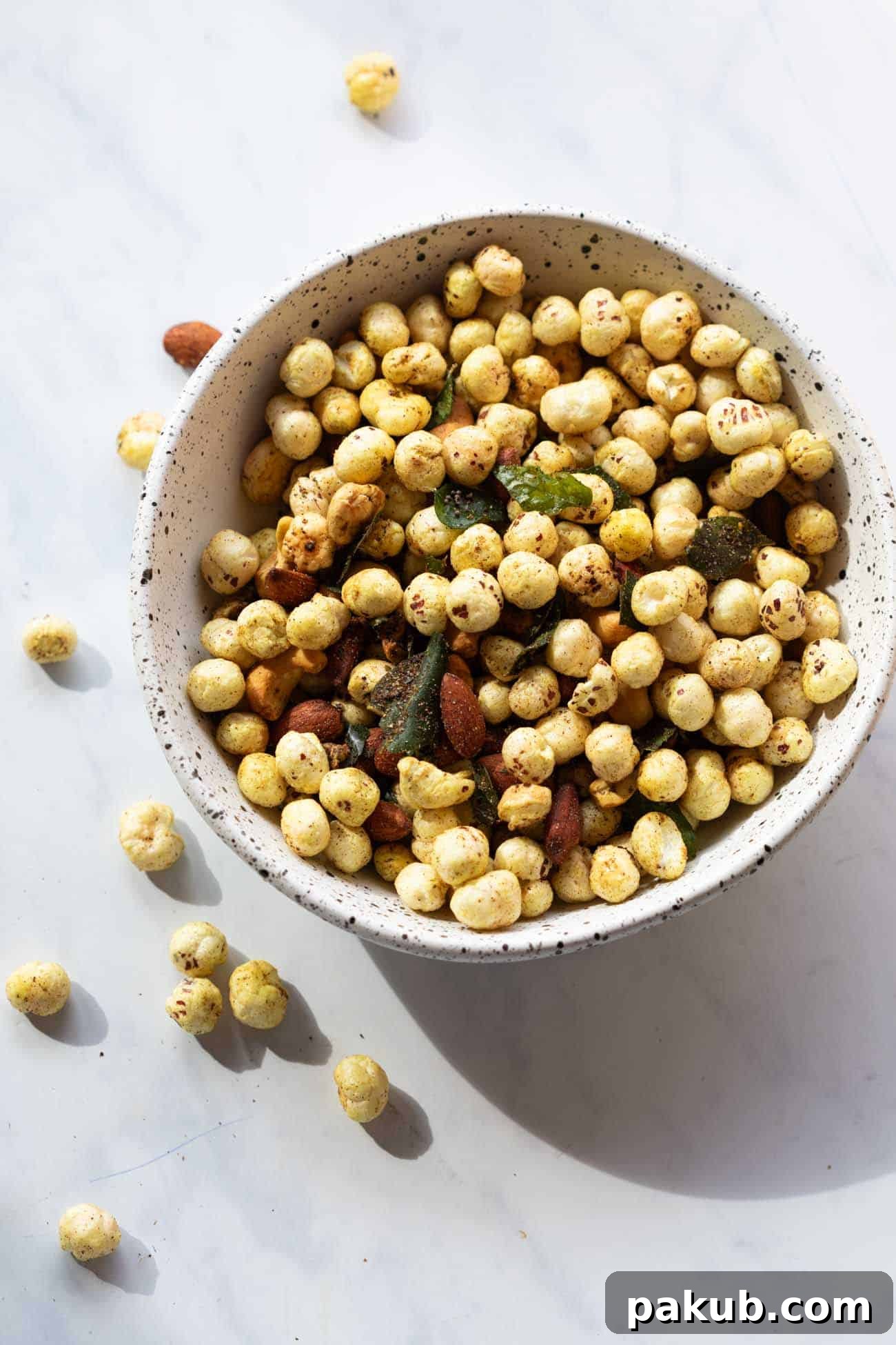 Air Fryer Crispy Makhana and Nut Snack 2 A bowl of golden, crispy Air Fryer Roasted Makhana and Nuts, garnished and ready to serve