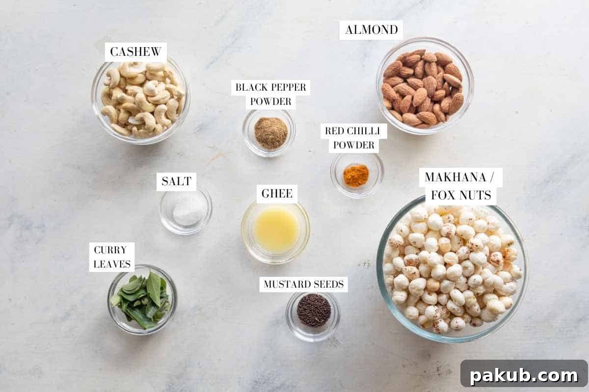 Air Fryer Crispy Makhana and Nut Snack 3 A flat lay of ingredients for air fryer roasted makhana and nuts, including makhana, almonds, cashews, ghee, mustard seeds, curry leaves, chaat masala, turmeric powder, and salt