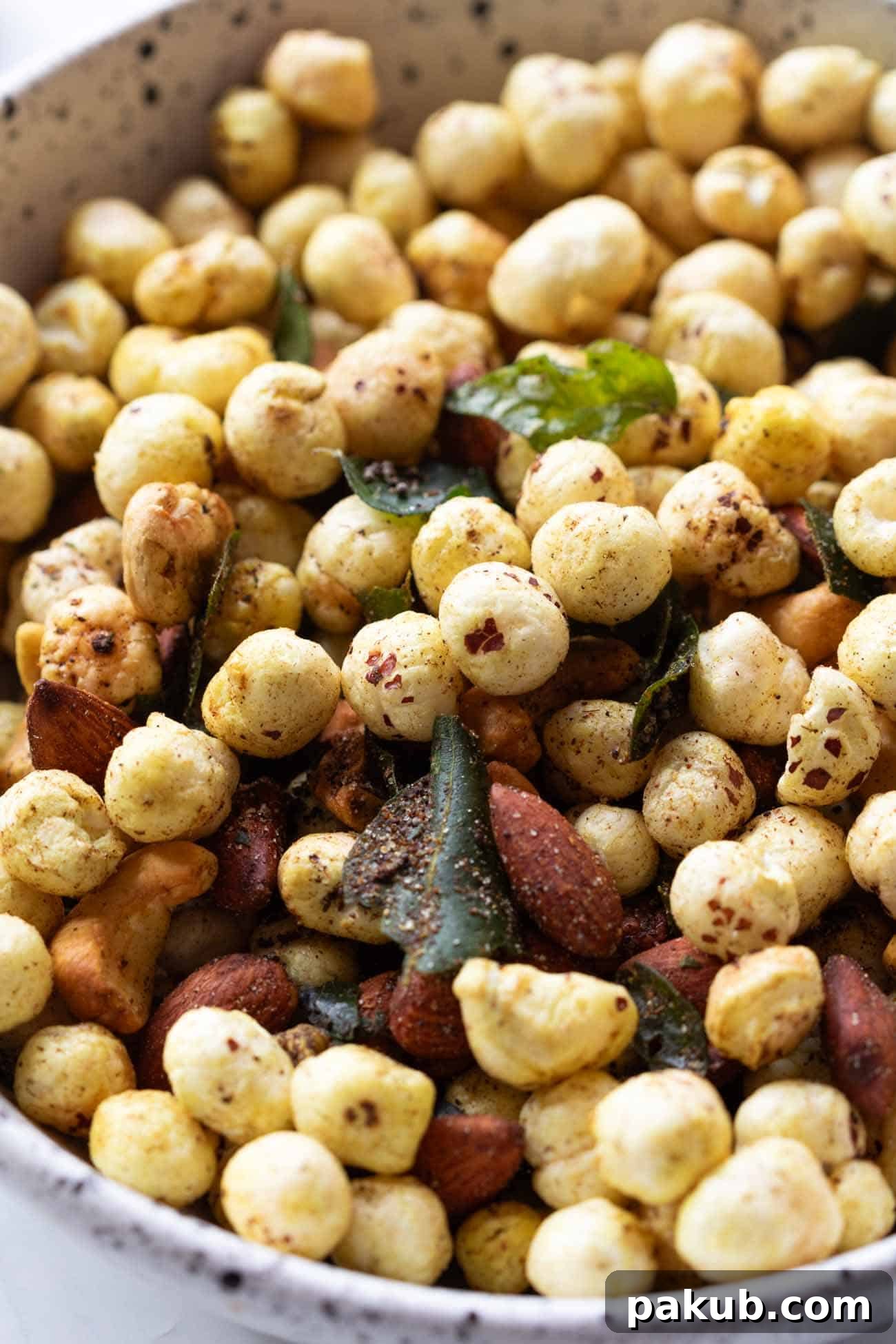 Air Fryer Crispy Makhana and Nut Snack 4 Close-up of golden brown, perfectly roasted makhana and mixed nuts in a white bowl