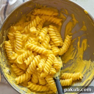 Carrot pasta sauce in a pan with a spatula
