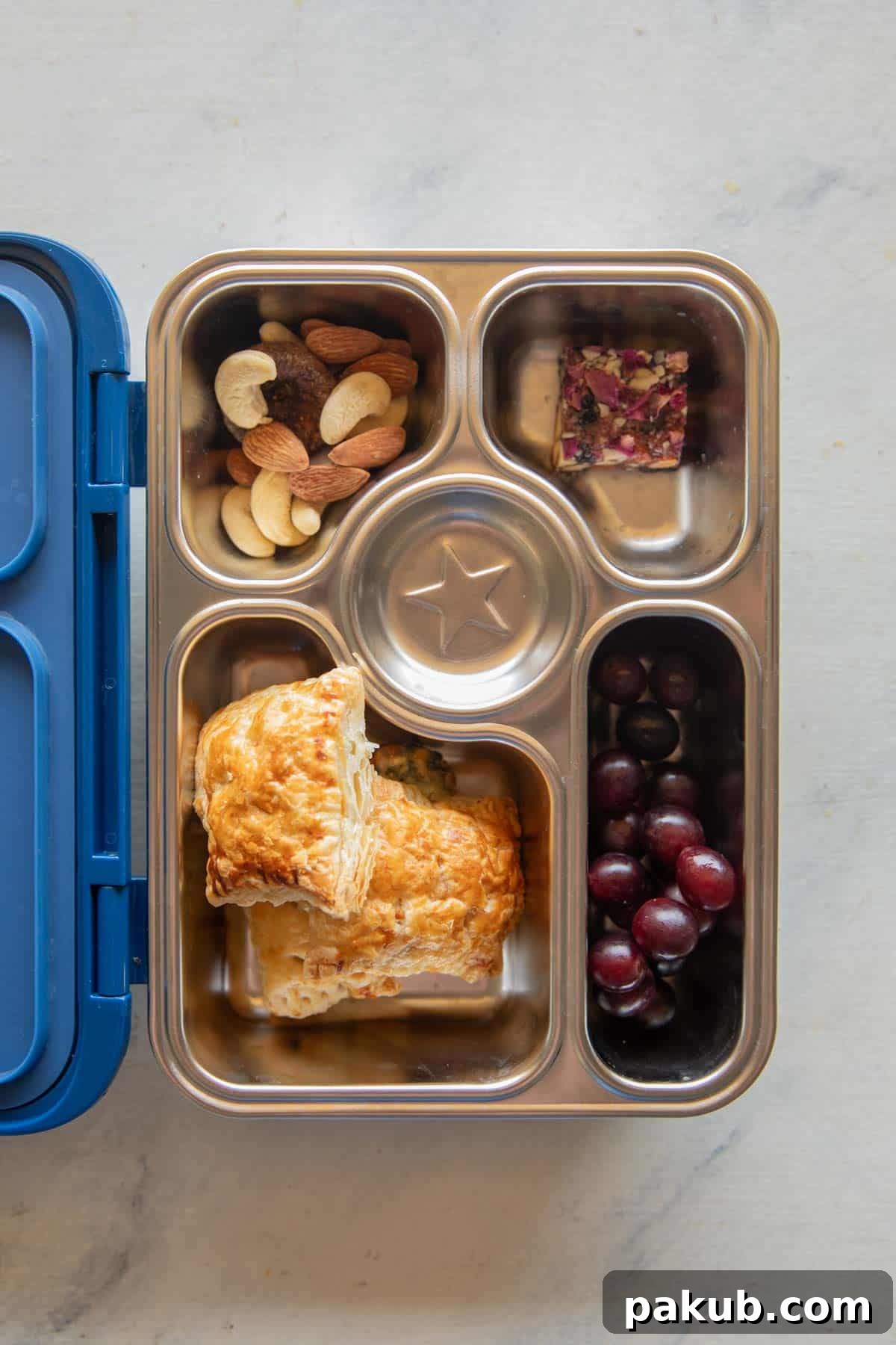 A vibrant shot of golden Corn Spinach Puffs neatly arranged in a colorful tiffin box, ready for school.