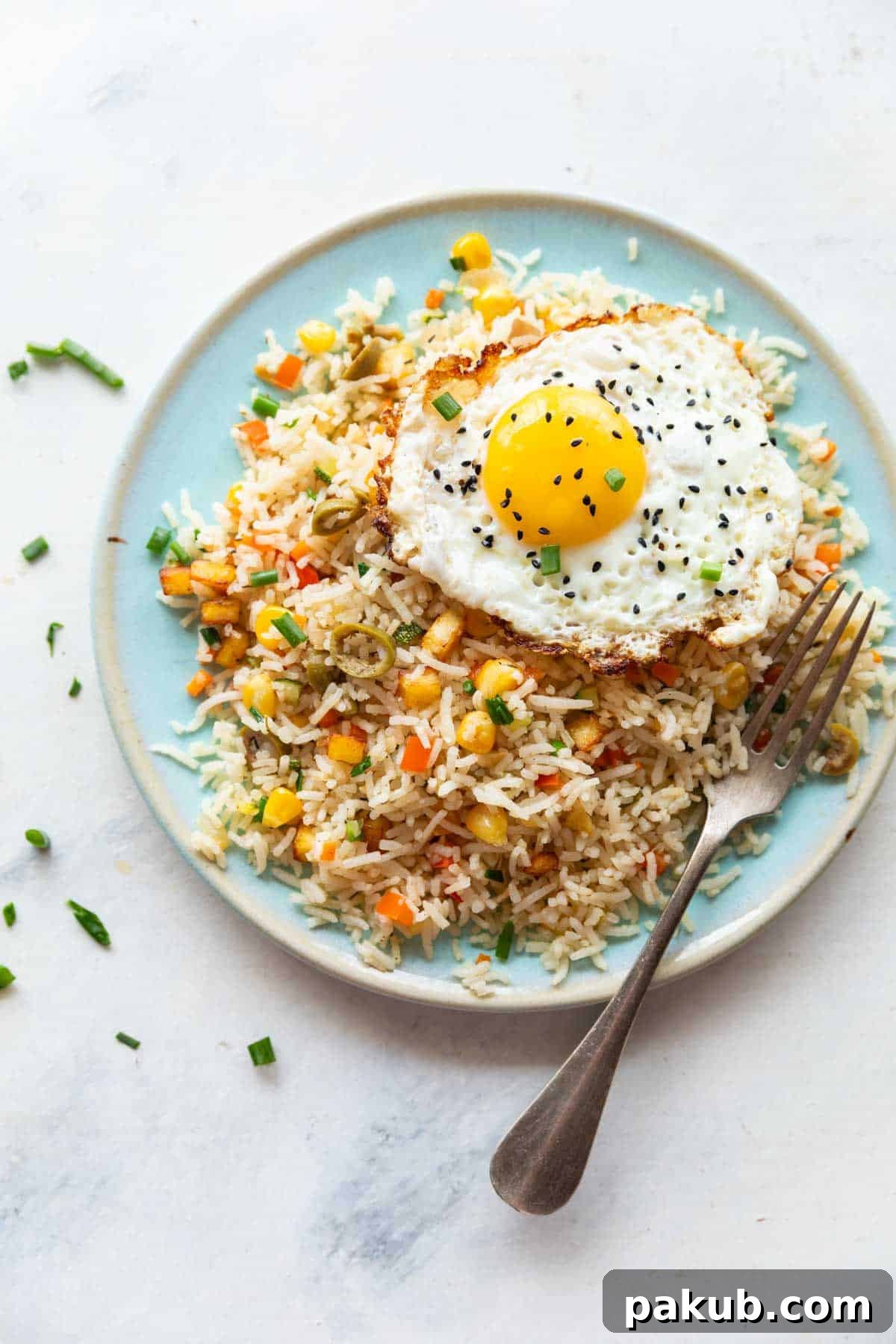 Party Sprinkles Rice 2 colourful rainbow rice on a blue plate with a sunny side up egg on top