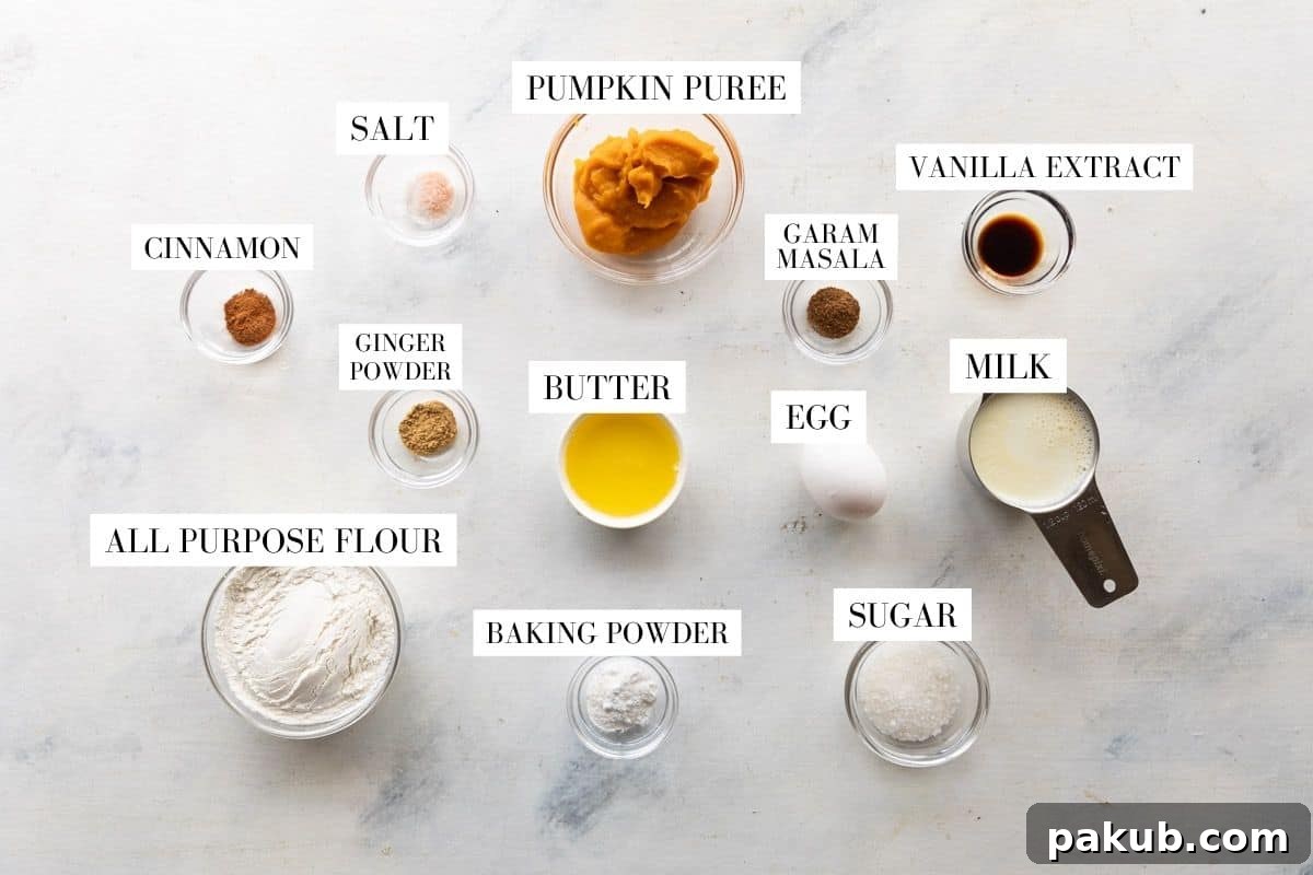Golden Pumpkin Spice Waffles 3 A flat lay photograph showcasing all the ingredients required for making pumpkin waffles, neatly arranged and labeled.