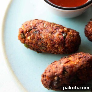 a close up shot of sprouts cutlet on a blue plate with ketchup on the side