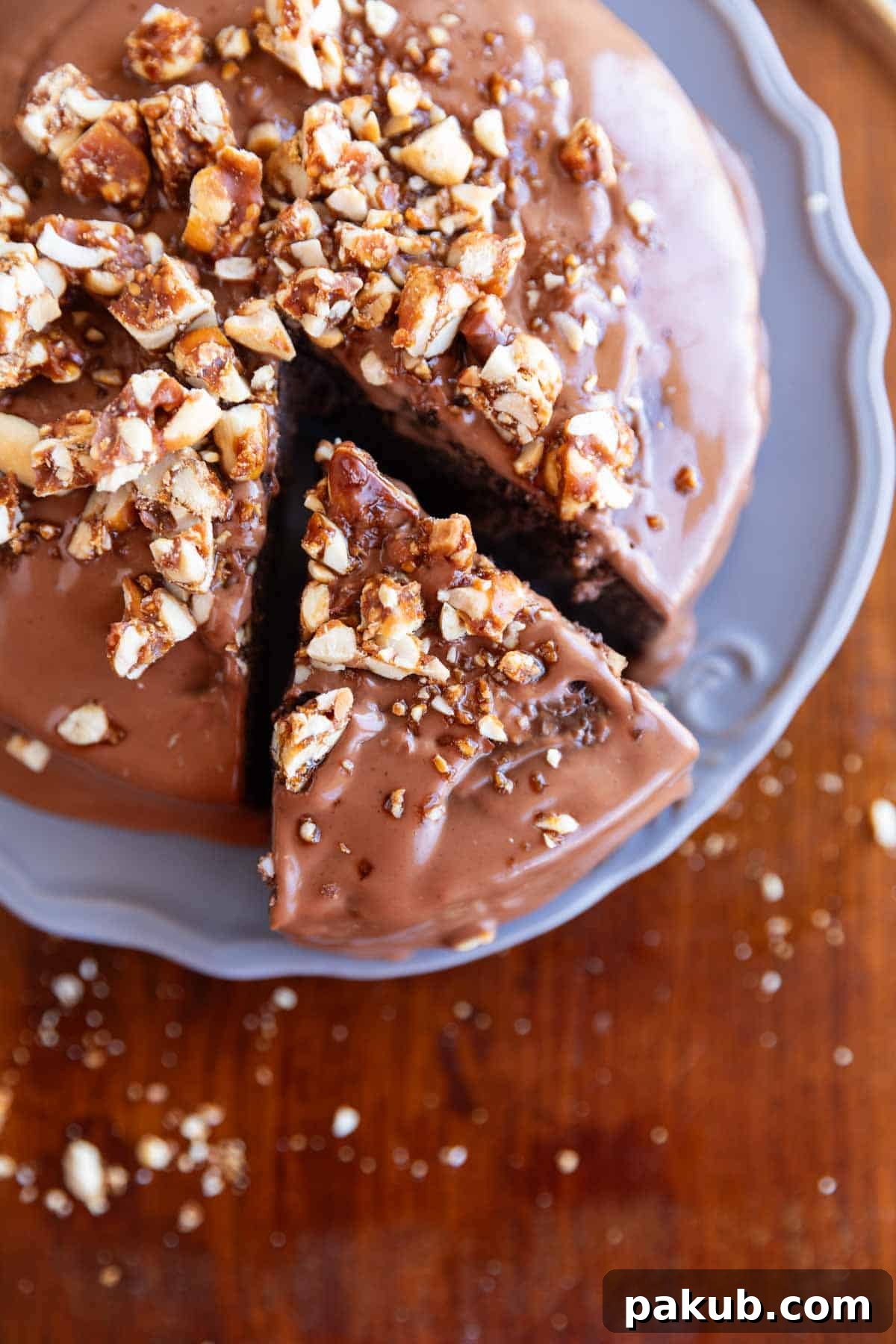Wholesome Chocolate Ragi Indulgence 2 Decadent ragi chocolate cake with creamy frosting and chopped nuts sprinkled on top, presented beautifully on a grey serving plate.