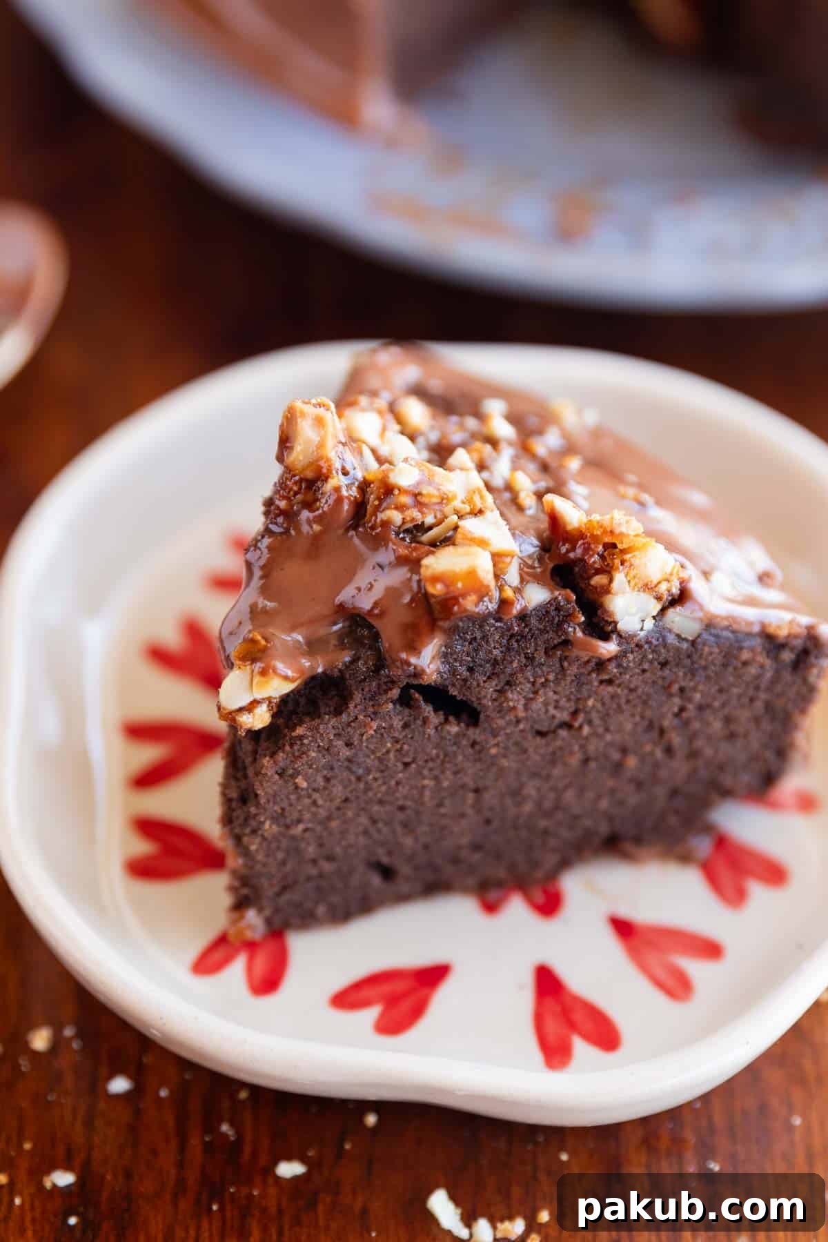Wholesome Chocolate Ragi Indulgence 4 A perfectly baked slice of moist ragi chocolate cake, adorned with crunchy nuts, resting on a pristine white plate, inviting a delicious bite.