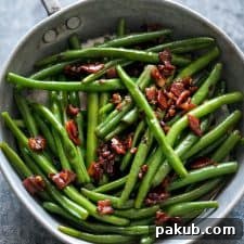 Sauteed Brown Sugar Bacon Garlic Green Beans in a glistening pan, ready to serve.