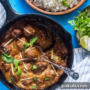 Easy One Pot Mutton (Lamb) Kofta Curry, garnished with fresh coriander and ginger, served alongside fragrant rice.