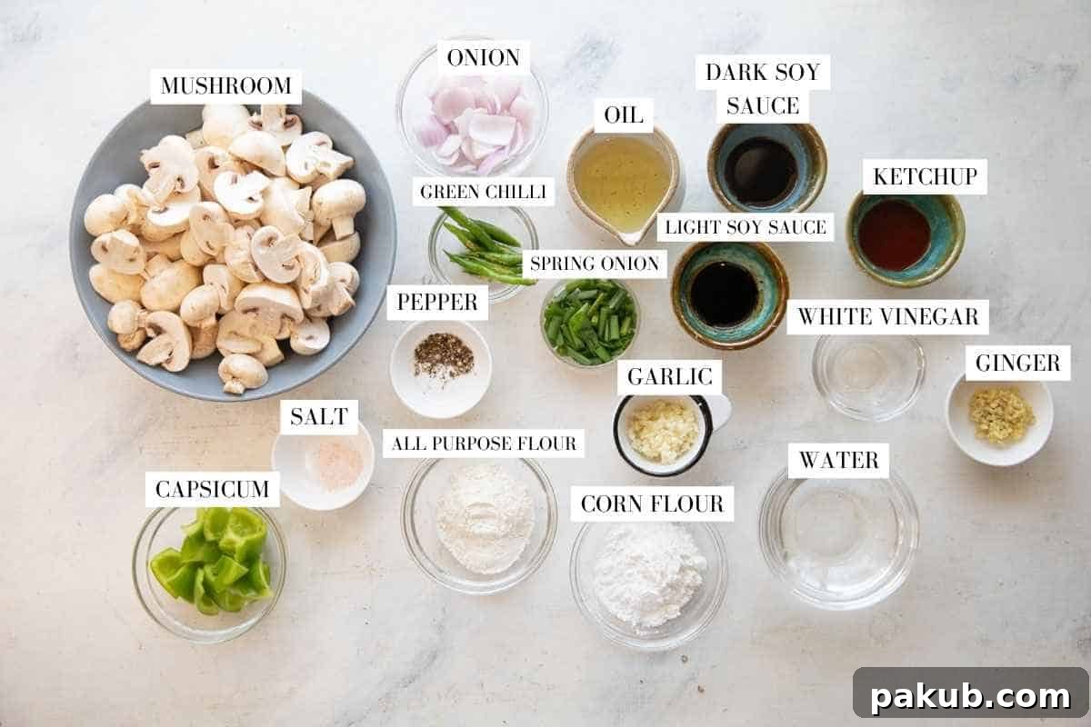 All the fresh ingredients laid out for making Air Fryer Mushroom Chilli, including mushrooms, bell peppers, onions, ginger, garlic, and sauces.