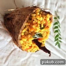 Mango rice served in a natural coconut shell, highlighting its tropical presentation.