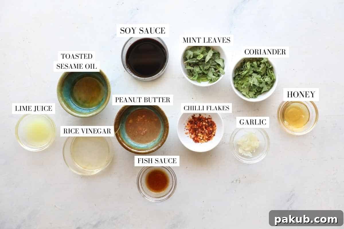 A selection of Asian Slaw dressing ingredients, including soy sauce, lime juice, honey, and peanut butter, prepared in small bowls