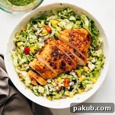 A wholesome Barley Chicken Salad with Herb Vinaigrette, served in a stylish grey bowl, ready to be enjoyed as a nutritious meal.