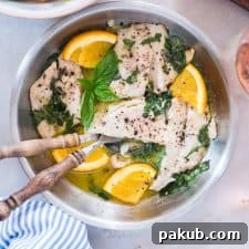 Exquisite Bhetki Fish in Citrus Basil Butter Sauce, served with a complementary glass of wine, creating a sophisticated and flavorful dining experience.