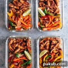 Colorful Chicken Fajita Meal Prep Lunch Bowls, featuring cilantro lime quinoa and grilled veggies, neatly arranged in glass containers for convenient healthy eating.