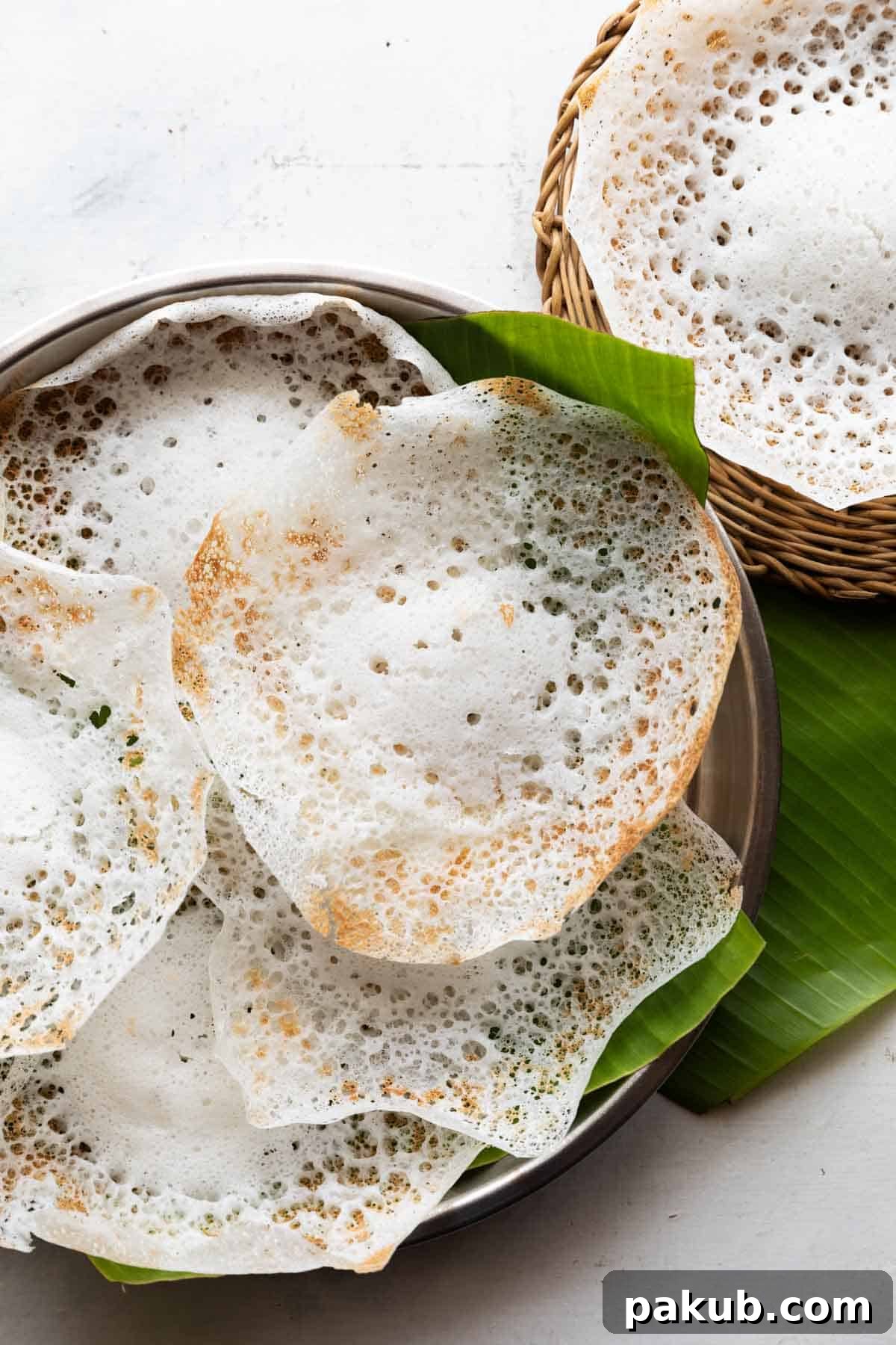 Velvety Tender Coconut Palappam 2 Tender coconut appam placed on a banana leaf, ready to serve